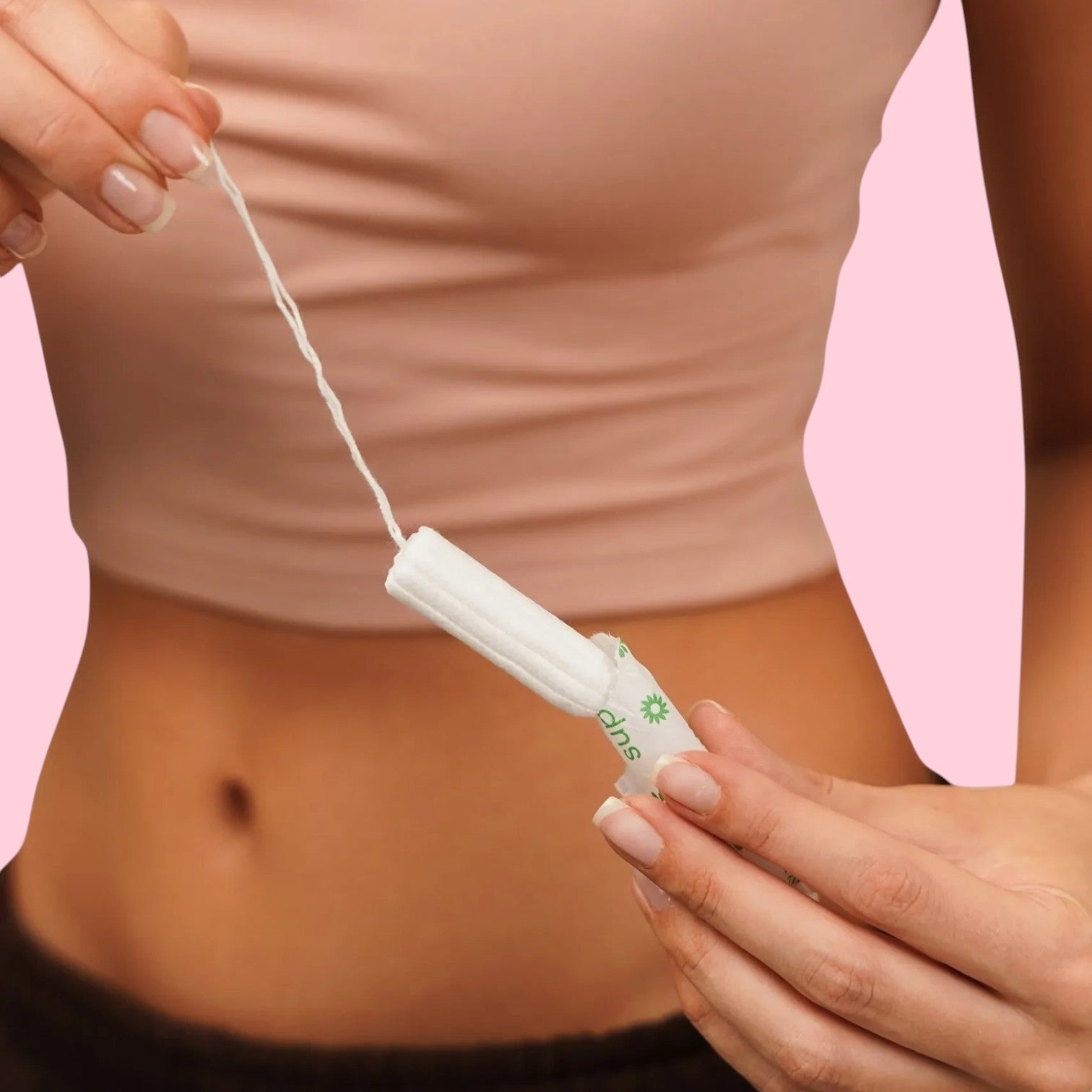 Gentle Day in South Africa organic cotton super tampon held by a person against a soft pink background.