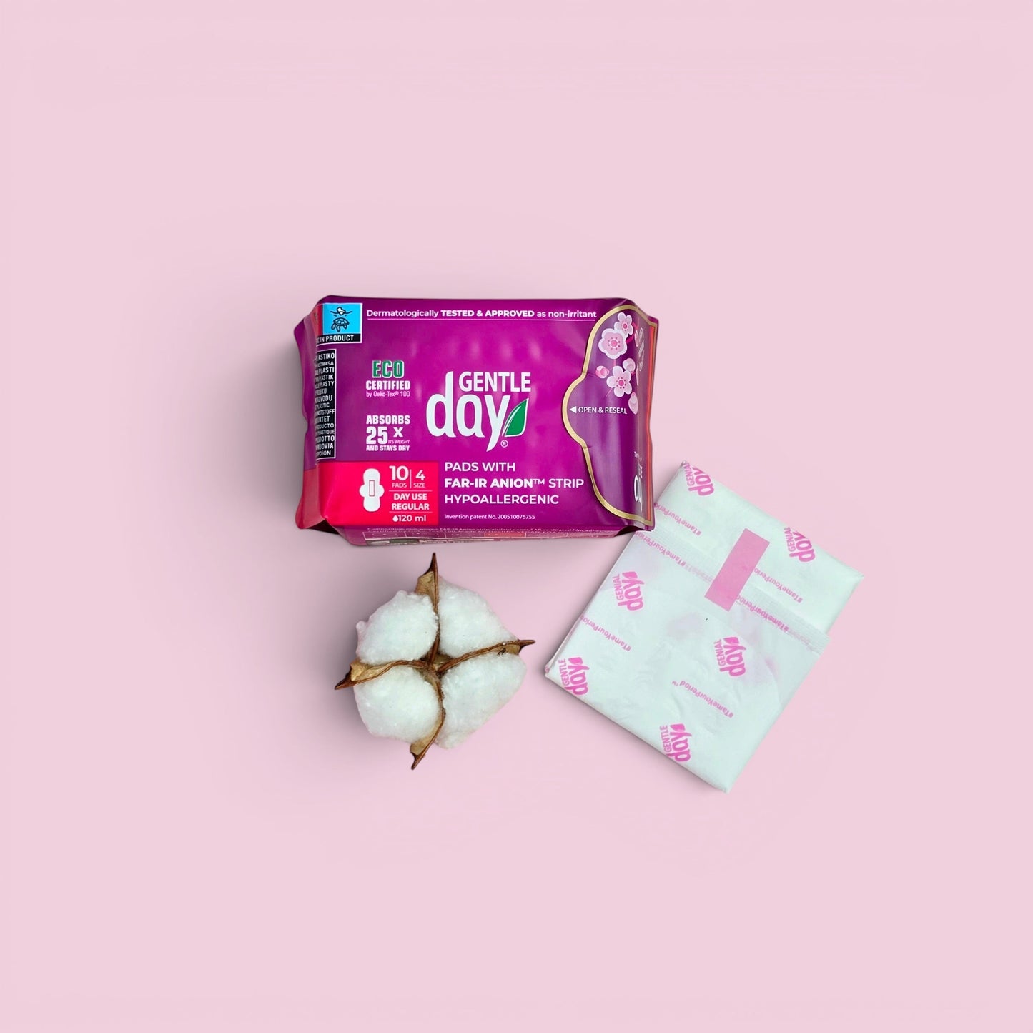 Gentle Day in South Africa organic regular flow pads with cotton boll and individually wrapped pad on pink background